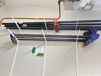 Overall view of pipe and bar clamps on wall rack