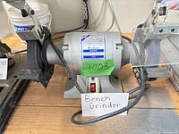 Front view of Jet bench grinder showing housing, wheels, tool rests and eye shields