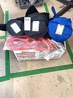 Overview showing three carry bags, orange cable chain components atop original Cobra Cam box