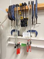 Full set of assorted clamps hanging on shelf