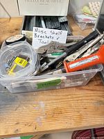 Bin with hand tools, screws, tubing and hardware