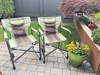 Two matching folding camping chairs on patio