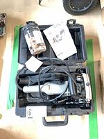 Tool, cord, dust bag and accessories inside carry case