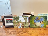 Group view showing framed portrait print, creek painting, hydrangea painting
