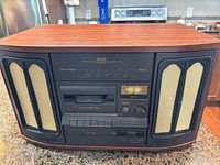 Front view showing speakers, cassette deck, CD tray, controls