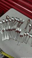 Full layout of flatware showing total pieces