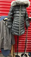 Front view of both coats on stands