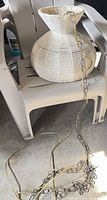 Full view of woven pendant lamp with chain and cord