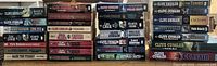 Four vertical stacks of Clive Cussler paperback novels