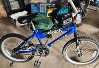 Full side view of Supercycle Clutch 20" blue bike showing frame, wheels, brakes, seat, chain guard, reflectors