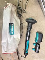 Massager, two attachments, storage bag, cord and plug visible