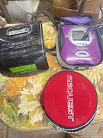Overall view showing clock radio, VideoNow player, red disc case
