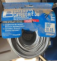 Front view of spool showing CommandLinx header card and coiled gray Cat5e cable