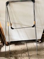 Full view of folding metal frame standing upright showing overall structure