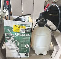 Sprayer next to original box showing components