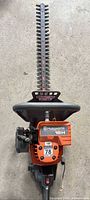 Full view of Husqvarna 18H hedge trimmer showing entire blade and engine housing