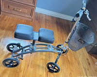 Overall view of knee scooter showing frame, wheels, seat, basket