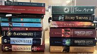 Two stacks of fifteen paperback fantasy books