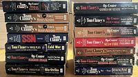 Two vertical stacks of Tom Clancy paperbacks front spines visible