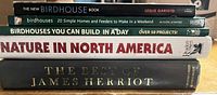 Stack of five hardcover books showing spines and titles