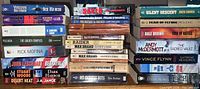 Left and right stacks of assorted paperback novels showing spines and titles
