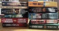 Front spines of all eleven paperbacks in two stacks