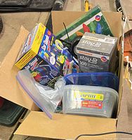 Box showing Star Shower projector, Sylvania 100-LED box, plastic bins and loose lights