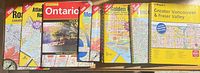 Eight spiral MapArt atlases laid out showing covers