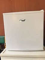 Front view of Master Chef mini fridge showing logo and white exterior