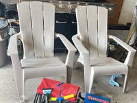 Front view of both resin Adirondack chairs showing color, design and wear