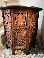 Side view showing pierced carved wood panels and overall structure