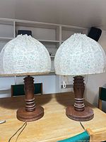 Front view of both table lamps on wooden surface
