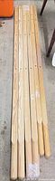 Six pine rails laid out side by side showing full length and rounded ends