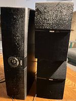 Front and side view of both RCA speakers showing overall design and dust