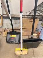 Front view showing both dustpans and broom