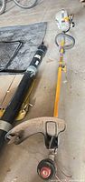 Full view of Ryobi gas string trimmer on floor