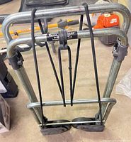 Full view of folded cart showing frame and elastic straps