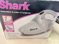 Retail box front showing Shark handheld vacuum image and model name