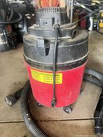 Shop-Vac 4 gallon vacuum on casters with hose attached