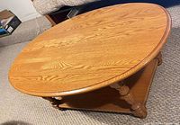 top view of oval light oak coffee table showing wood grain