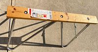 Folding sawhorse full view showing wood top and steel legs