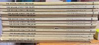 Spines of 13 matching Sesame Street Treasury volumes showing numbering