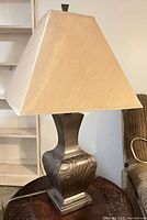 Lamp full view on table showing base and shade