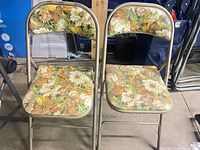 Two matching Cooey folding chairs side by side