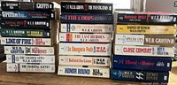 Two tall stacks of W.E.B. Griffin paperbacks showing spines and titles