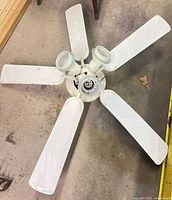 Top view of white 5-blade ceiling fan