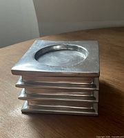 top angle showing square shape, recessed candle area, brushed aluminum surface