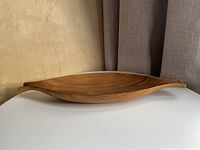 side profile of wooden tray showing curved shape