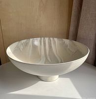 Side profile showing footed base and glaze texture