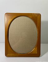 Front view of teak frame showing oval opening and overall design